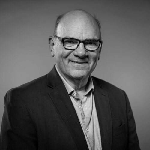 black and white headshot of man with hat
