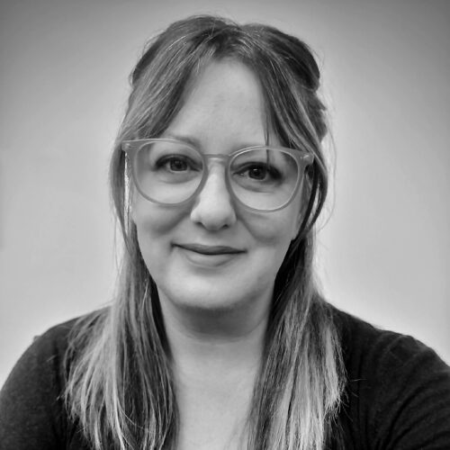 woman with glasses smiling