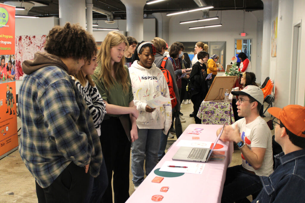 A group of students get information at the Spring 2023 Career Fair in SITE1212 at the Art Academy of Cincinnati.