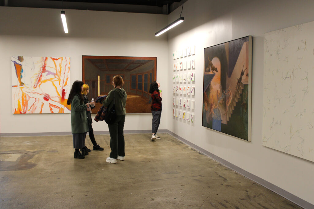 Visitors view artwork as part of Stewart Goldman's Cross Currents exhibition in SITE1212 at the Art Academy of Cincinnati.