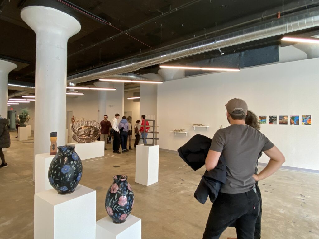 Visitors observe ceramics and artwork as part of the NCECA conference in SITE1212 at the Art Academy of Cincinnati.