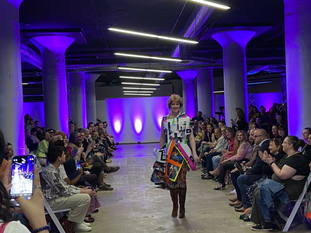 A model walks the runway in the HRC Project Rainbow Fashion Show in SITE1212 at the Art Academy of Cincinnati.