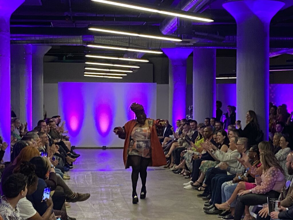 A model walks the runway in the HRC Project Rainbow Fashion Show in SITE1212 at the Art Academy of Cincinnati.