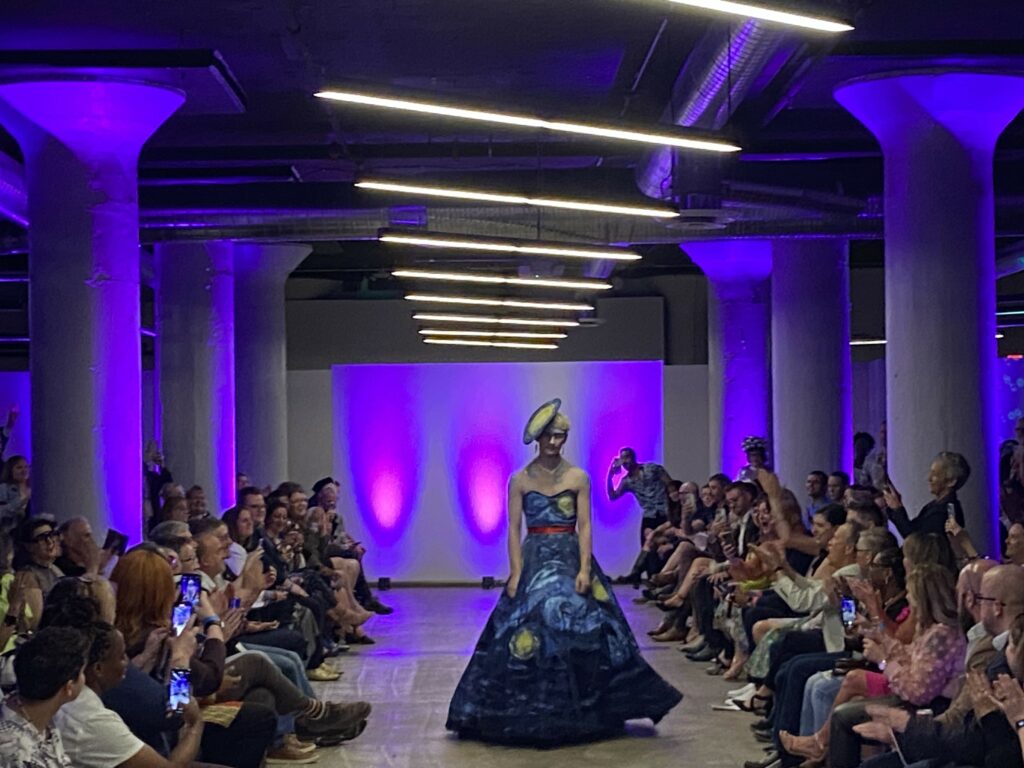 A model walks the runway in the HRC Project Rainbow Fashion Show in SITE1212 at the Art Academy of Cincinnati.