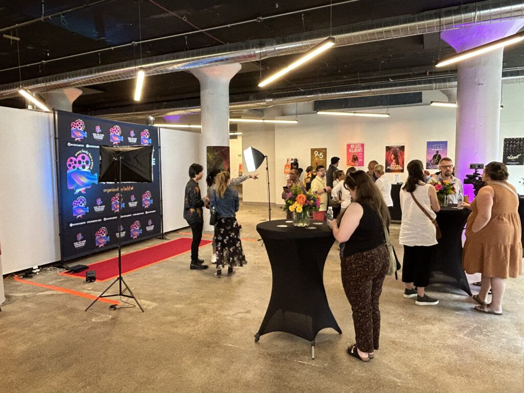 A crowd waits for their film to begin in the lobby of the 2023 OTR Film Festival in SITE1212 at the Art Academy of Cincinnati.