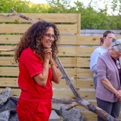 woman smiling in red jumpsuit