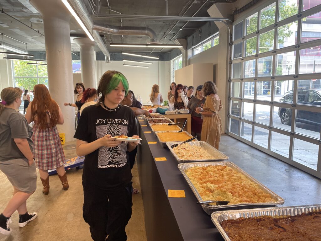 Students get food in SITE1212 on the concluding day of 2023 Orientation Week.