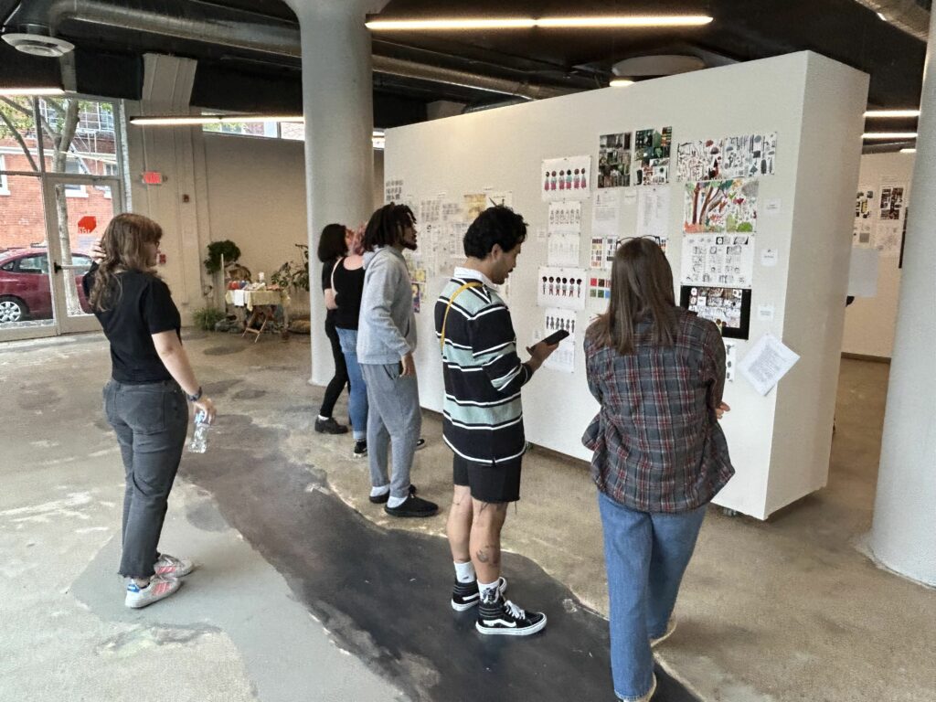 Art Academy of Cincinnati students view artwork on display at the 2023 Fall Walk Around in SITE1212.