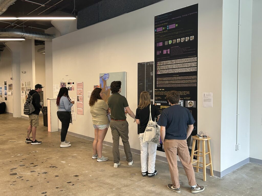 Art Academy of Cincinnati students view artwork on display at the 2023 Fall Walk Around in SITE1212.