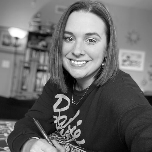 Woman Smiling holding a pen