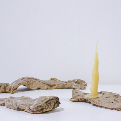 Ceramic pieces with abstract shapes with candle ontop of one made by artist Gabriella Bourgeois