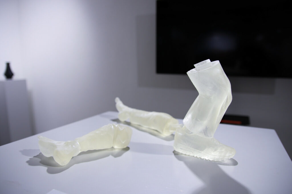 Three clear sculptures of limbs