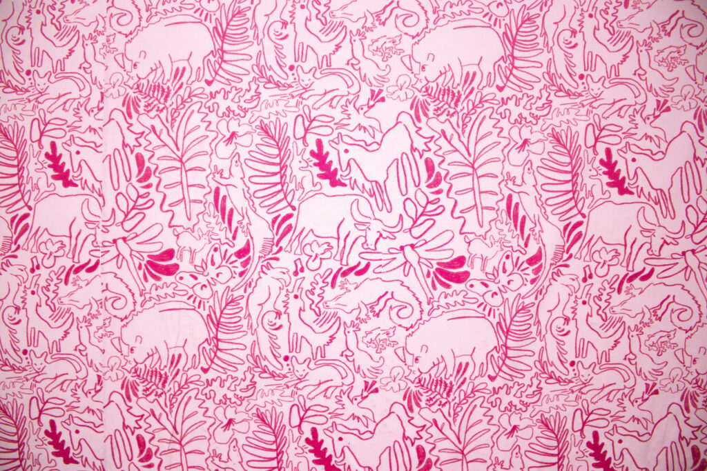 A dark pink on light pink pattern depicting various animals and leaves.