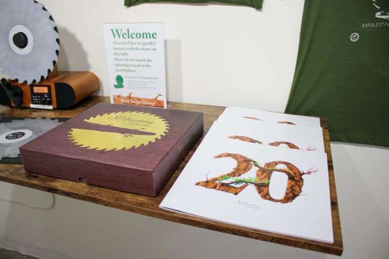 A custom-designed booklet and box accompanied by a specialized "Welcome" sign.