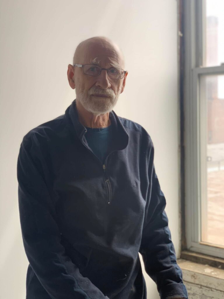 photo of a man (Gary Gaffney) posing by a window who's in-memoriam scholarship is offered at the Art academy of Cincinnati