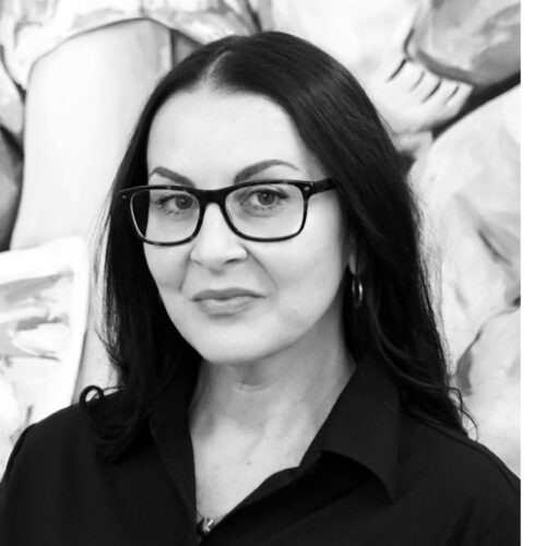 Woman in glasses and small smile