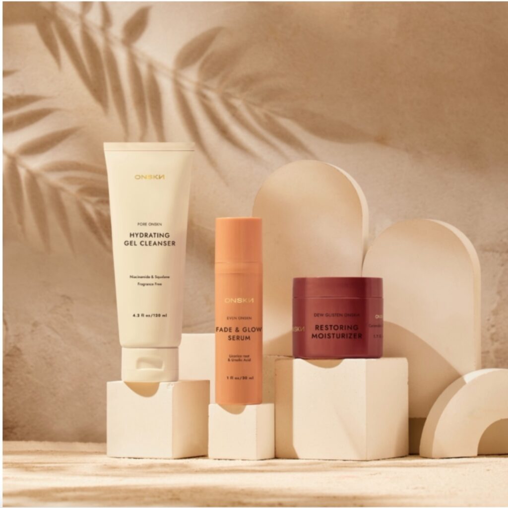 Multiple face products on a tabletop with floral shadows