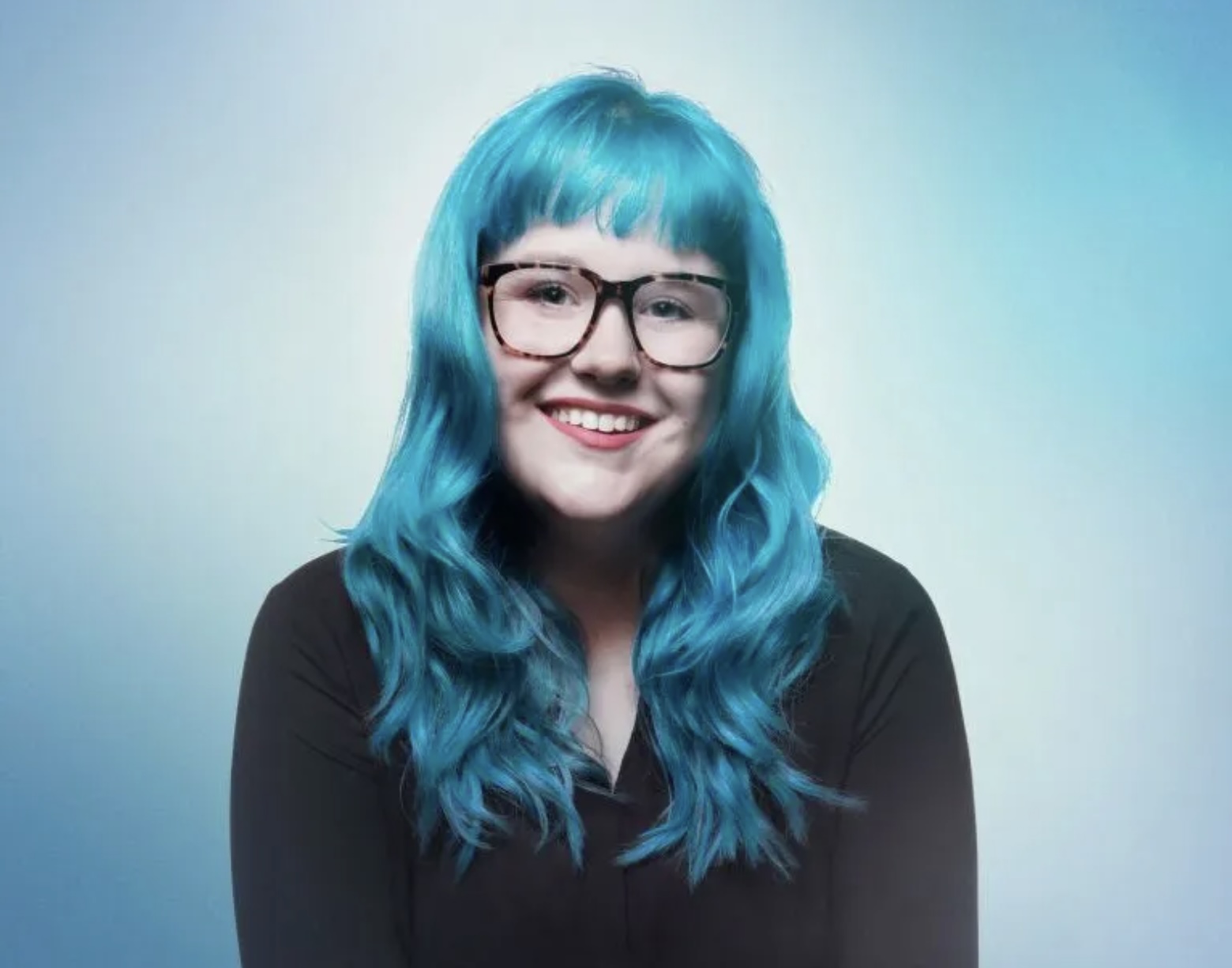 Photo of Marci Rhodes with Blue Hair and glasses