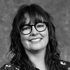 woman with glasses smiling