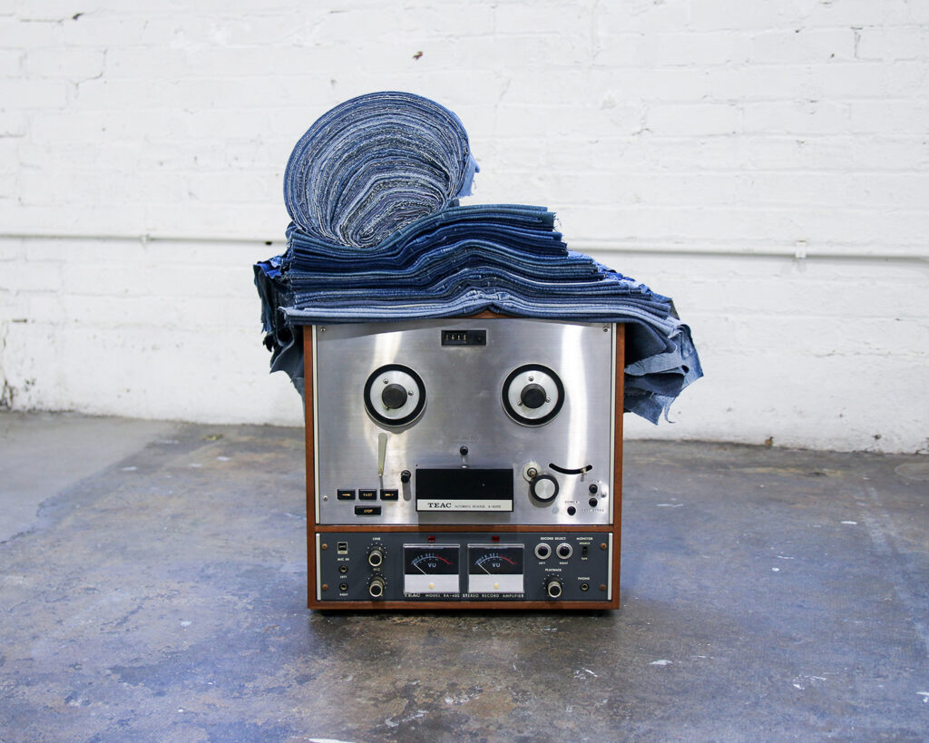 A photo of a sculpture made with electronics and denim