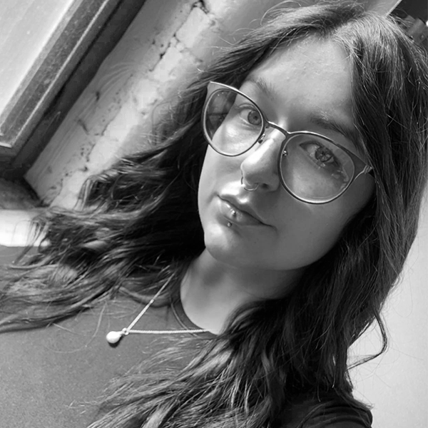 black and white headshot of a woman with glasses