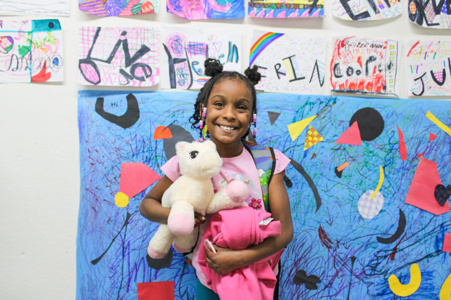 smiling kid in front of art