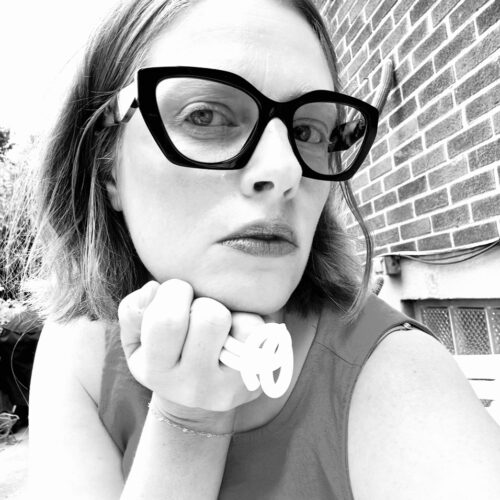 black and white portrait of a woman with black glasses