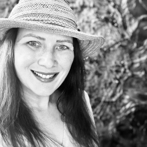 photo of a smiling woman with a hat on