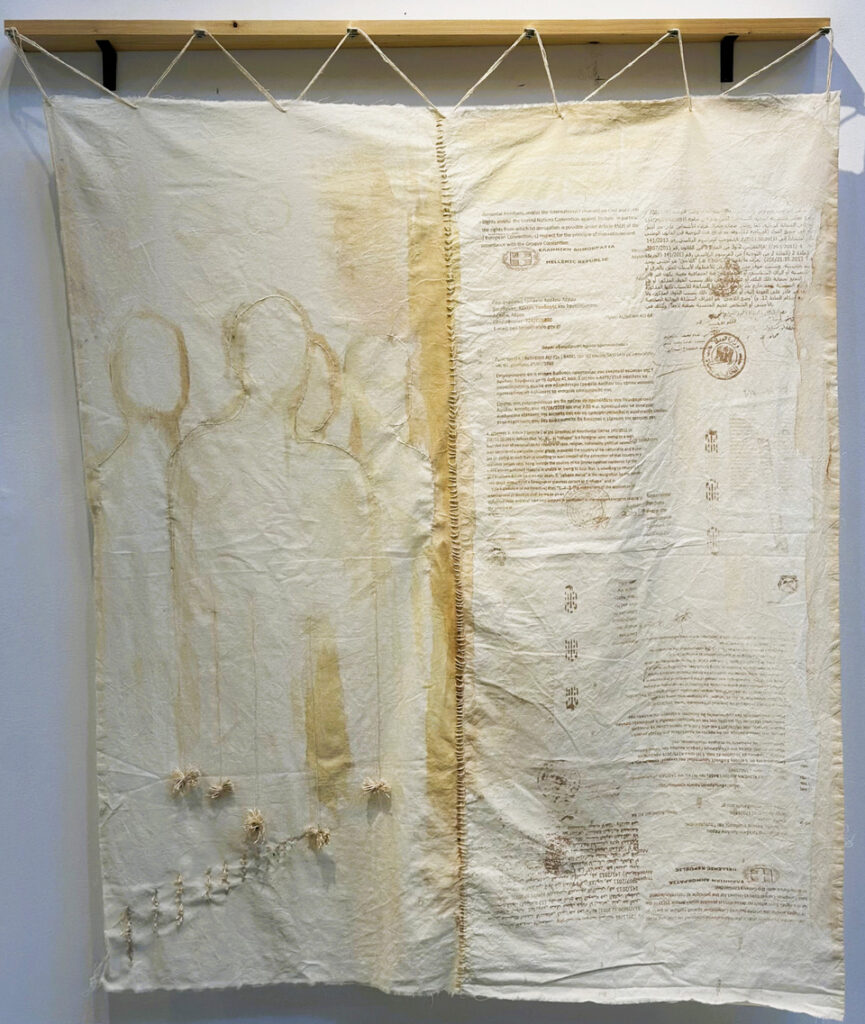 hanging textile art with text printed on it