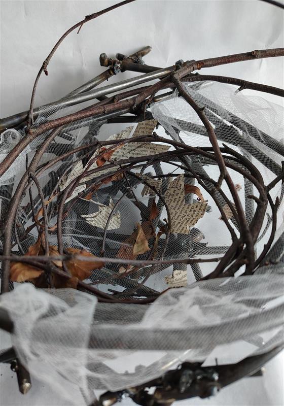 sculpture collage of sticks net and paper