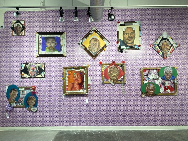 paintings of portraits hanging on wallpaper