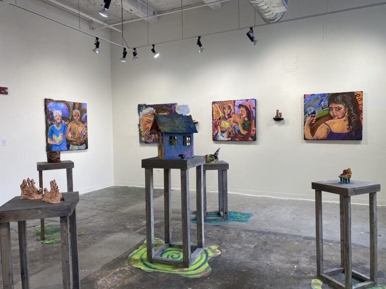 paintings and sculptures in a gallery