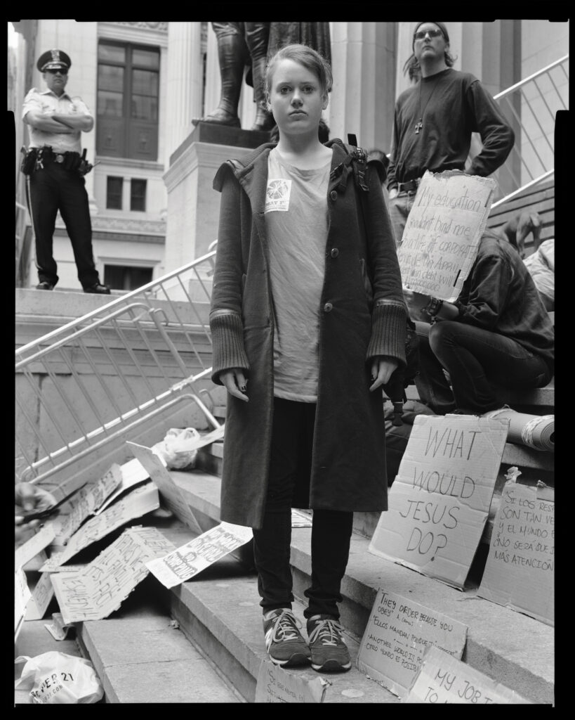 black and white photo of a girl protesting on steps by Accra Shepp
