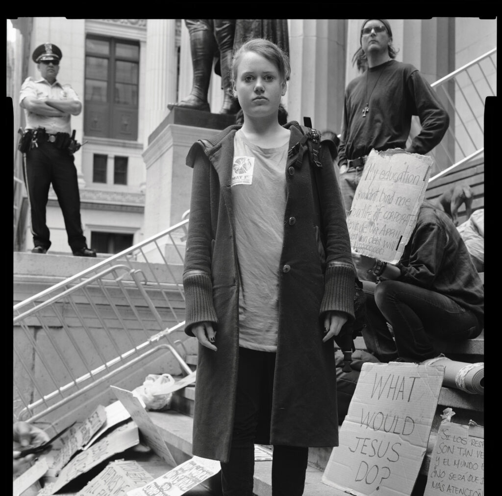 black and white photo of a girl protesting on steps by Accra Shepp