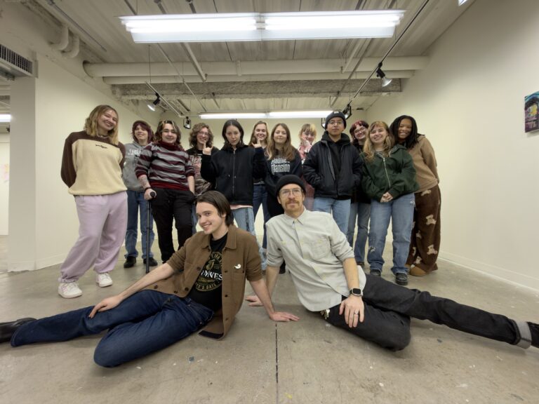 students posing in white gallery