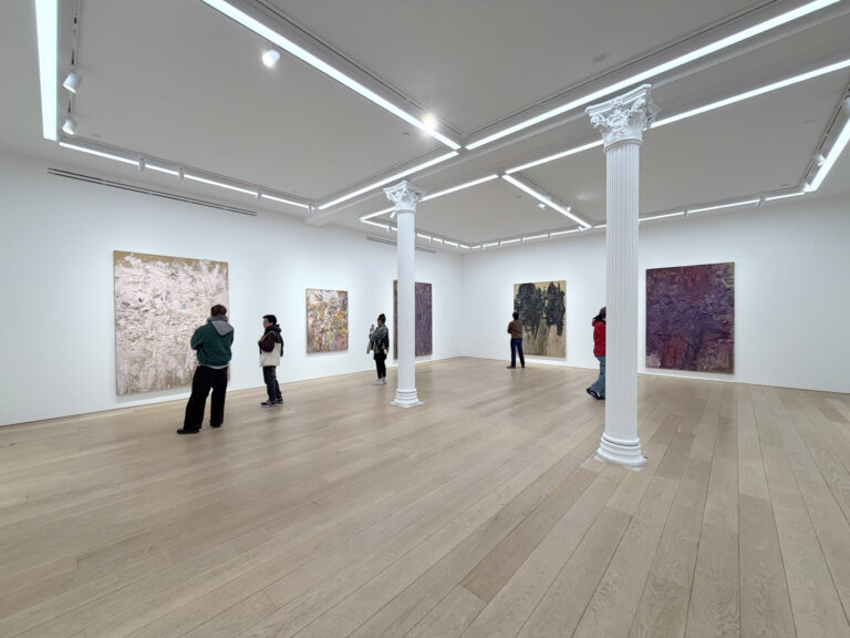 students looking at paintings in a large New York gallery