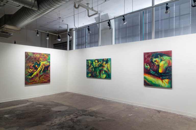 figure paintings in a gallery, yellows and greens